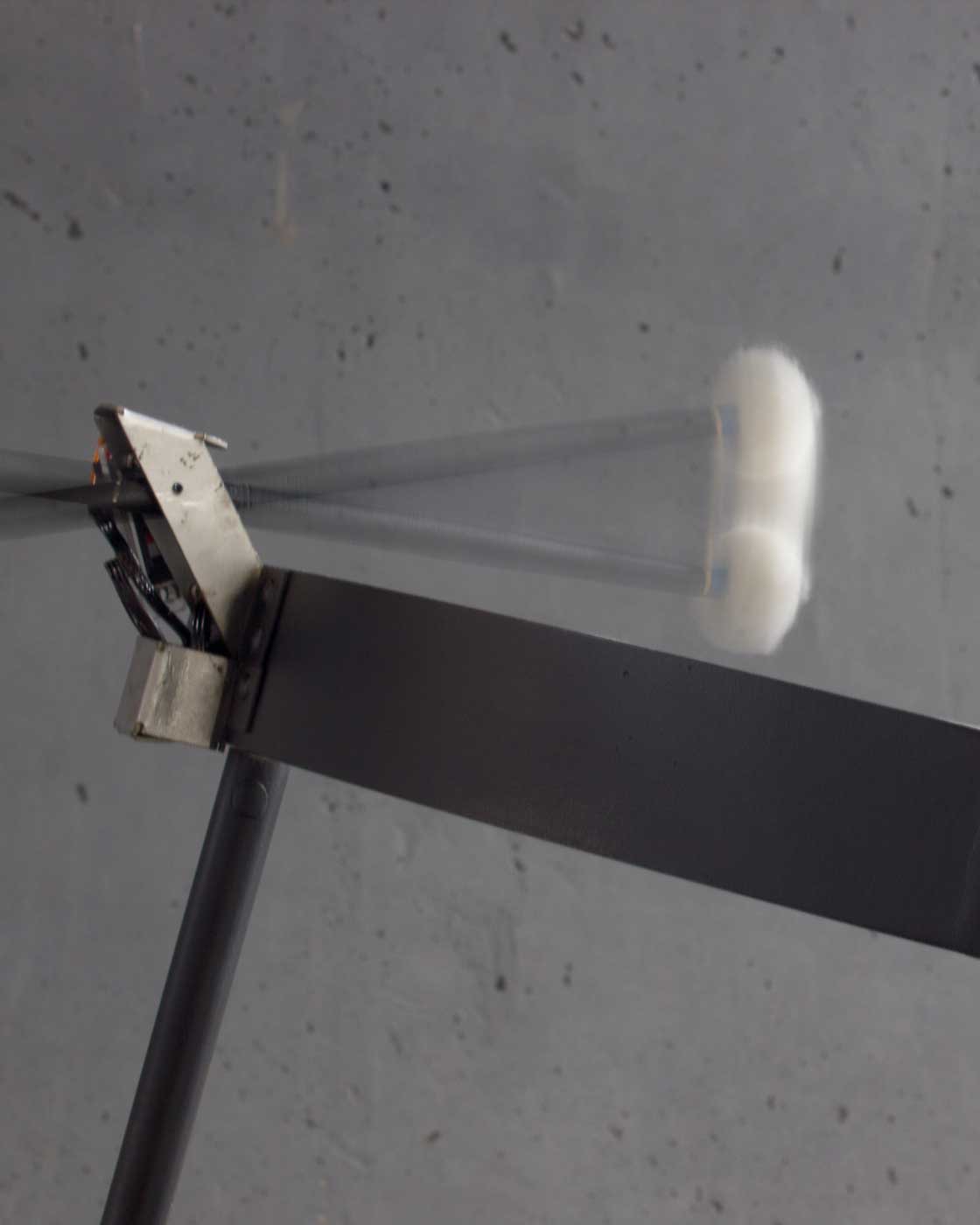 A closeup of a mallet striking the drum.